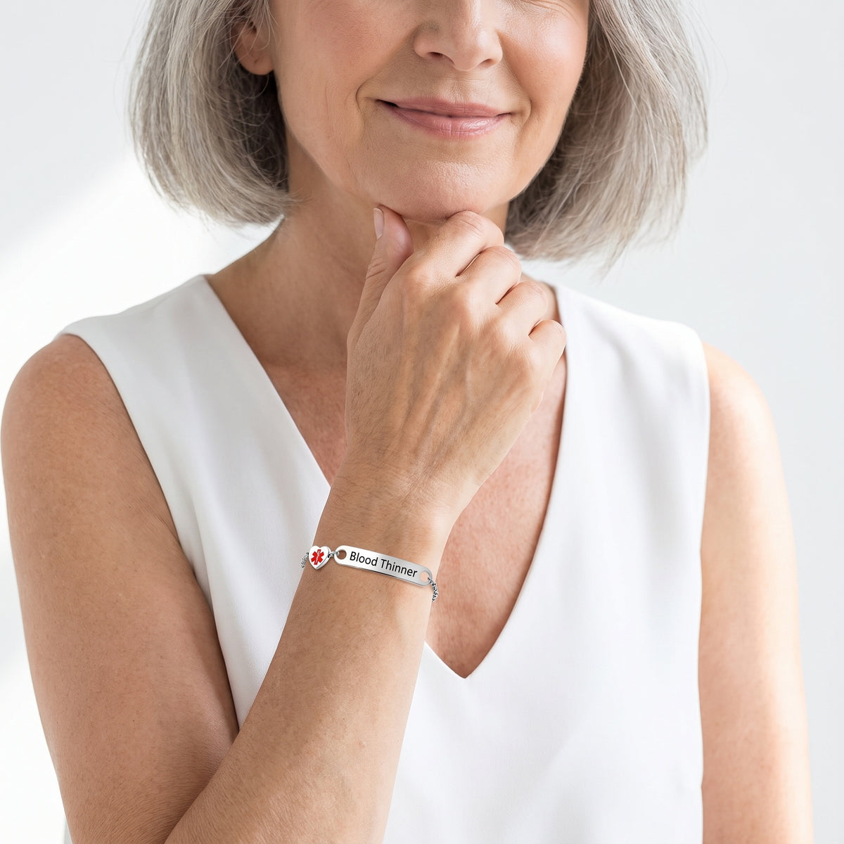 Smiling woman in her 60s showing the Cynora bracelet on her wrist